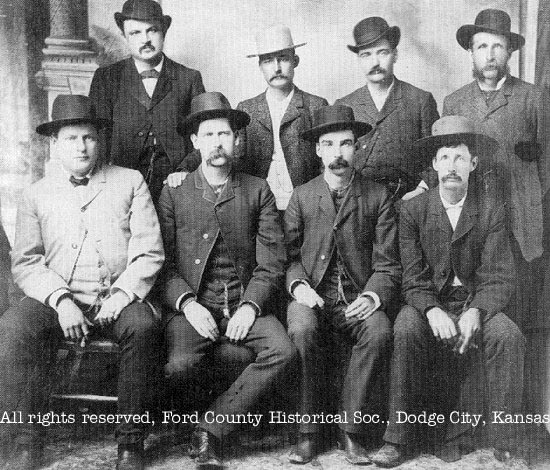 [Photo: Original photograph of the 'Dodge City Peace Commission' in
June, 1883. Front, l-r; Chas. E. Basset, Wyatt S. Earp, Frank McLain, and
Neil Brown. Back, l-r; W. H. Harris, Luke Short, W. B. Bat Masterson, and
W. F. Petillon. This is the version with Petillon beside Masterson. All
rights reserved. FCHS.]